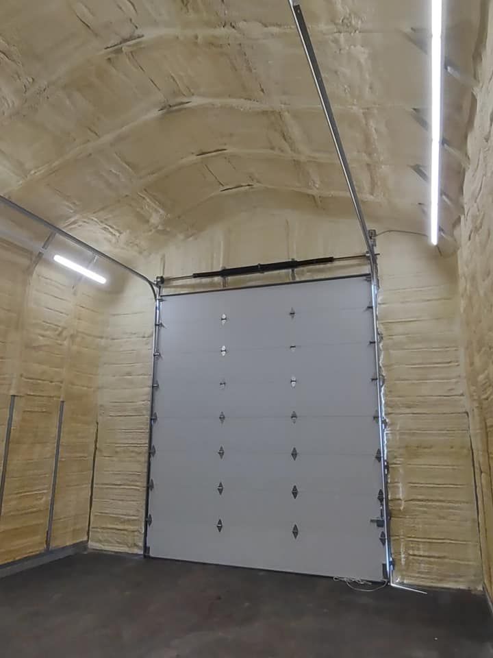 An empty garage with a large garage door.