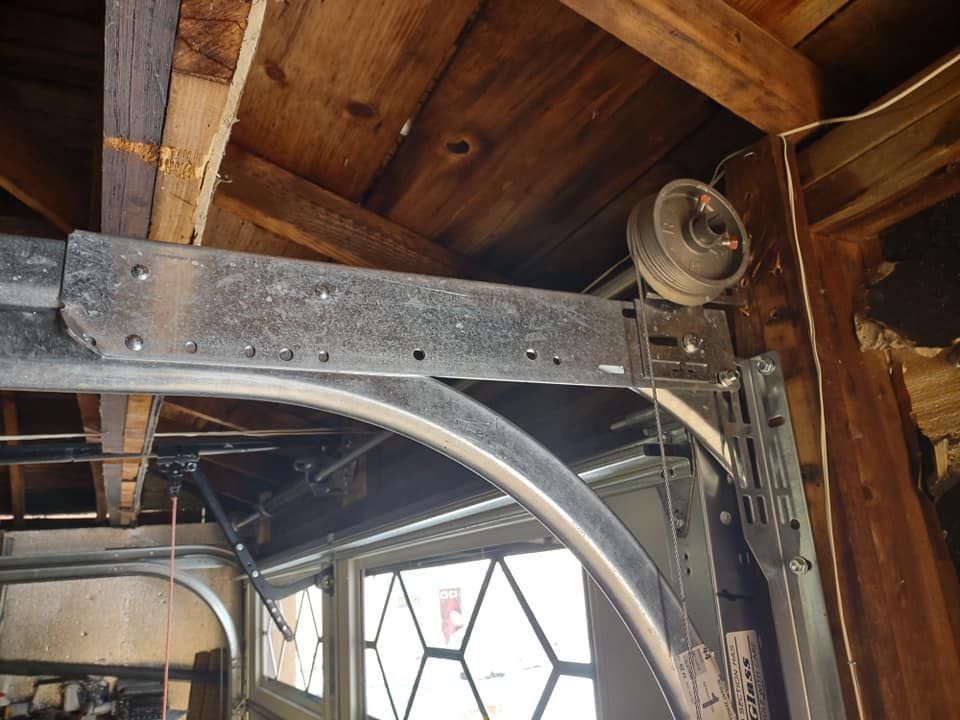 A close up of a garage door with a wheel on it