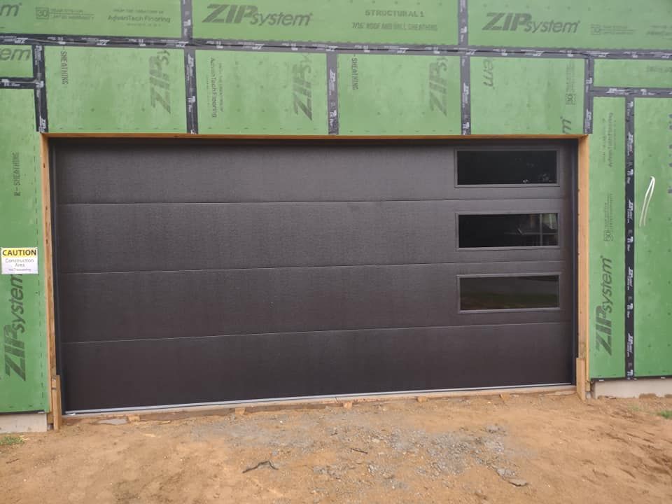 A garage door with a green wall behind it that says zip system