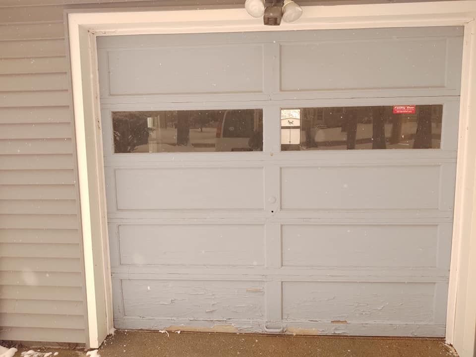 A blue garage door with a light on top of it