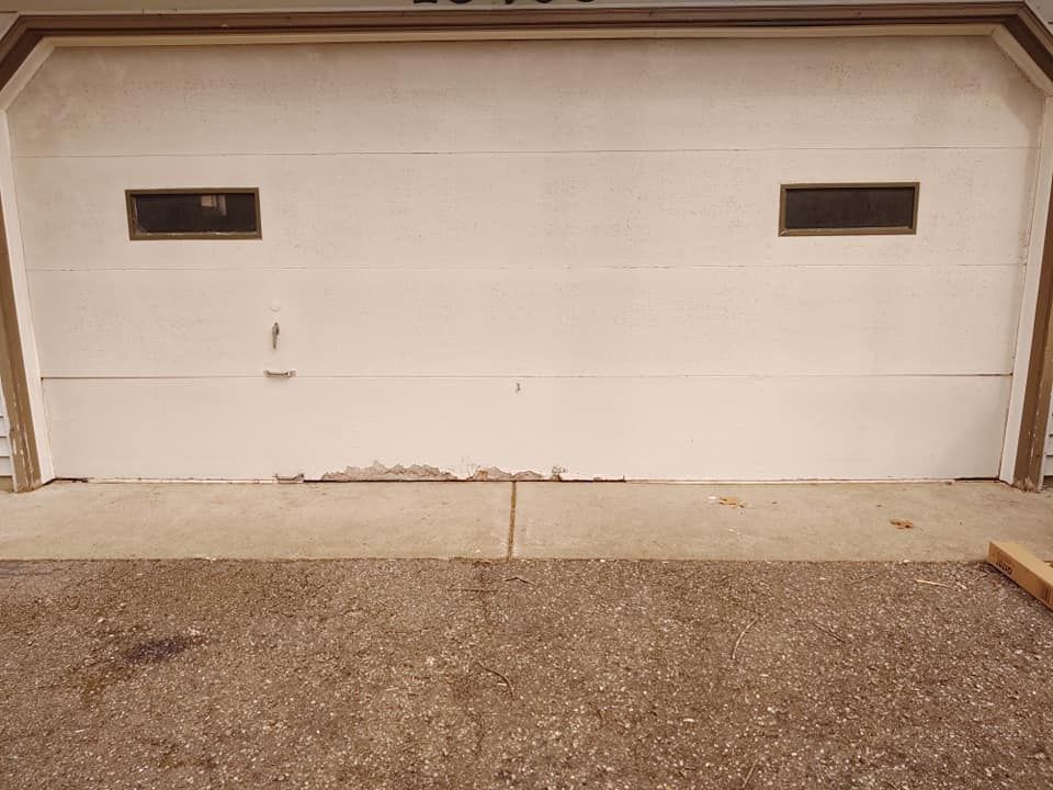 A white garage door with a small window in it