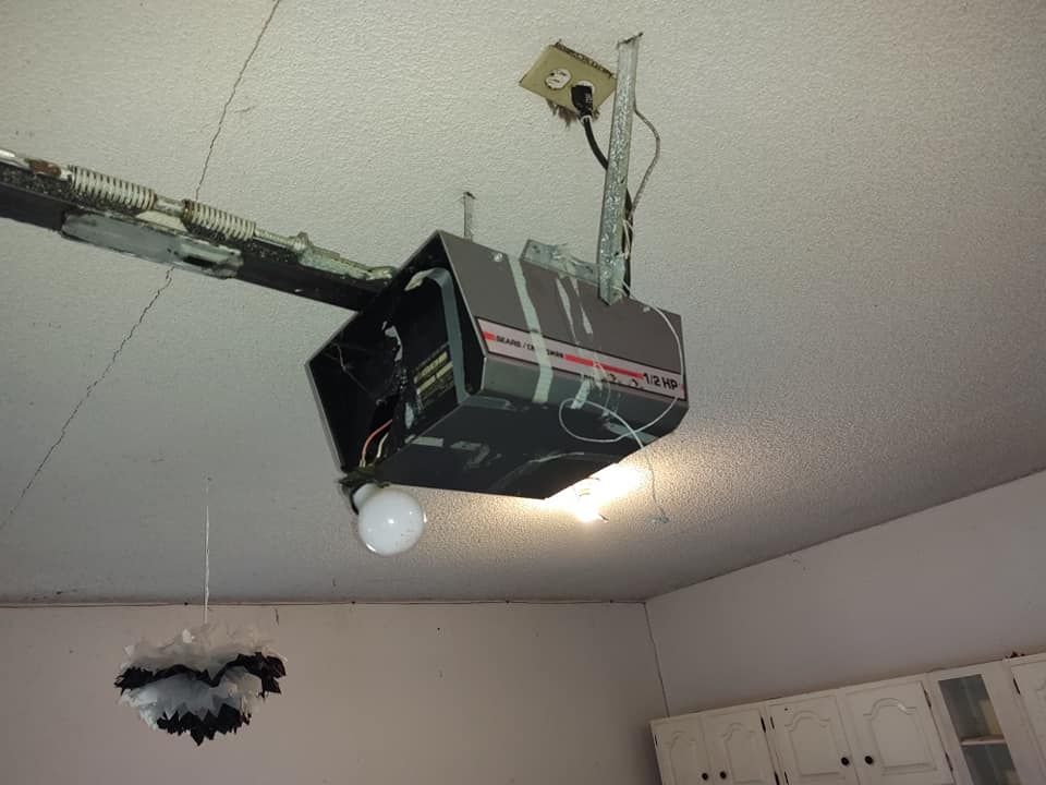 A garage door opener is hanging from the ceiling in a room