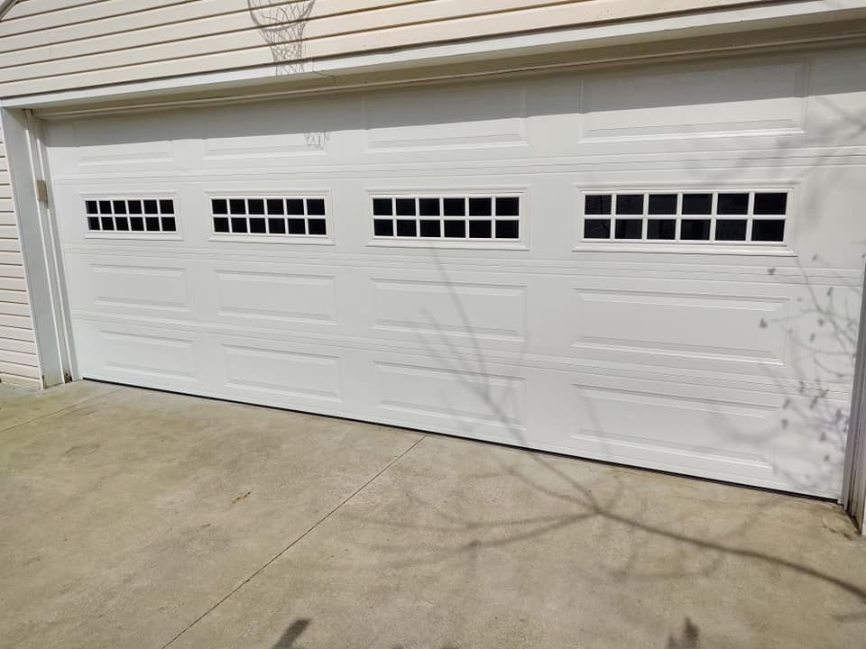A white garage door with a lot of windows on it.