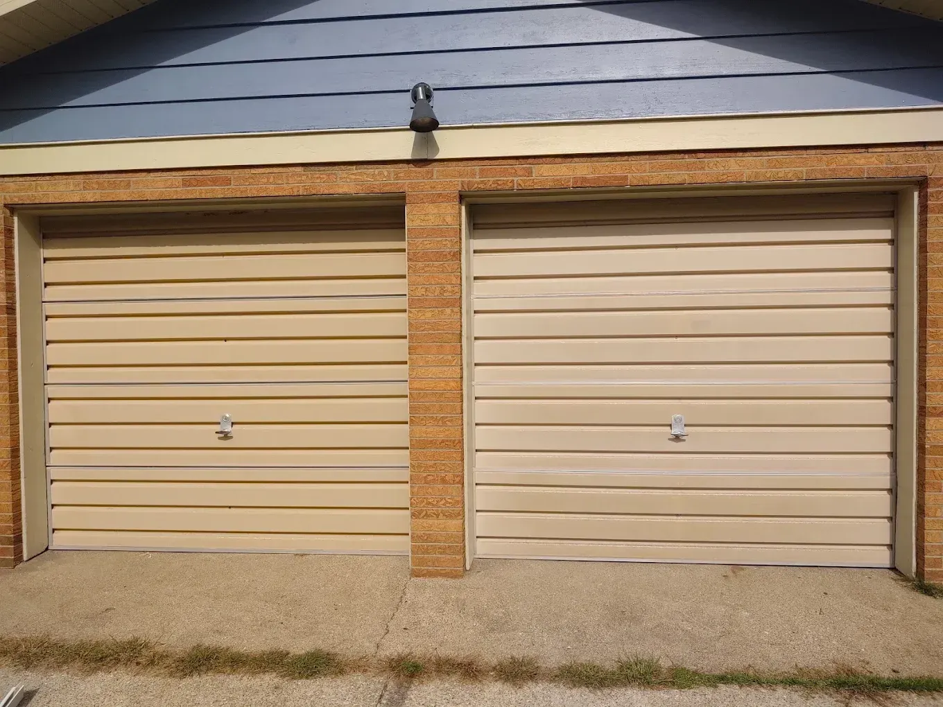 A house with two garage doors that are open