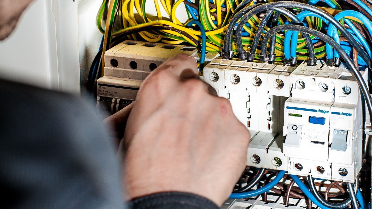 A metal roof with a skylight against a bright blue sky.