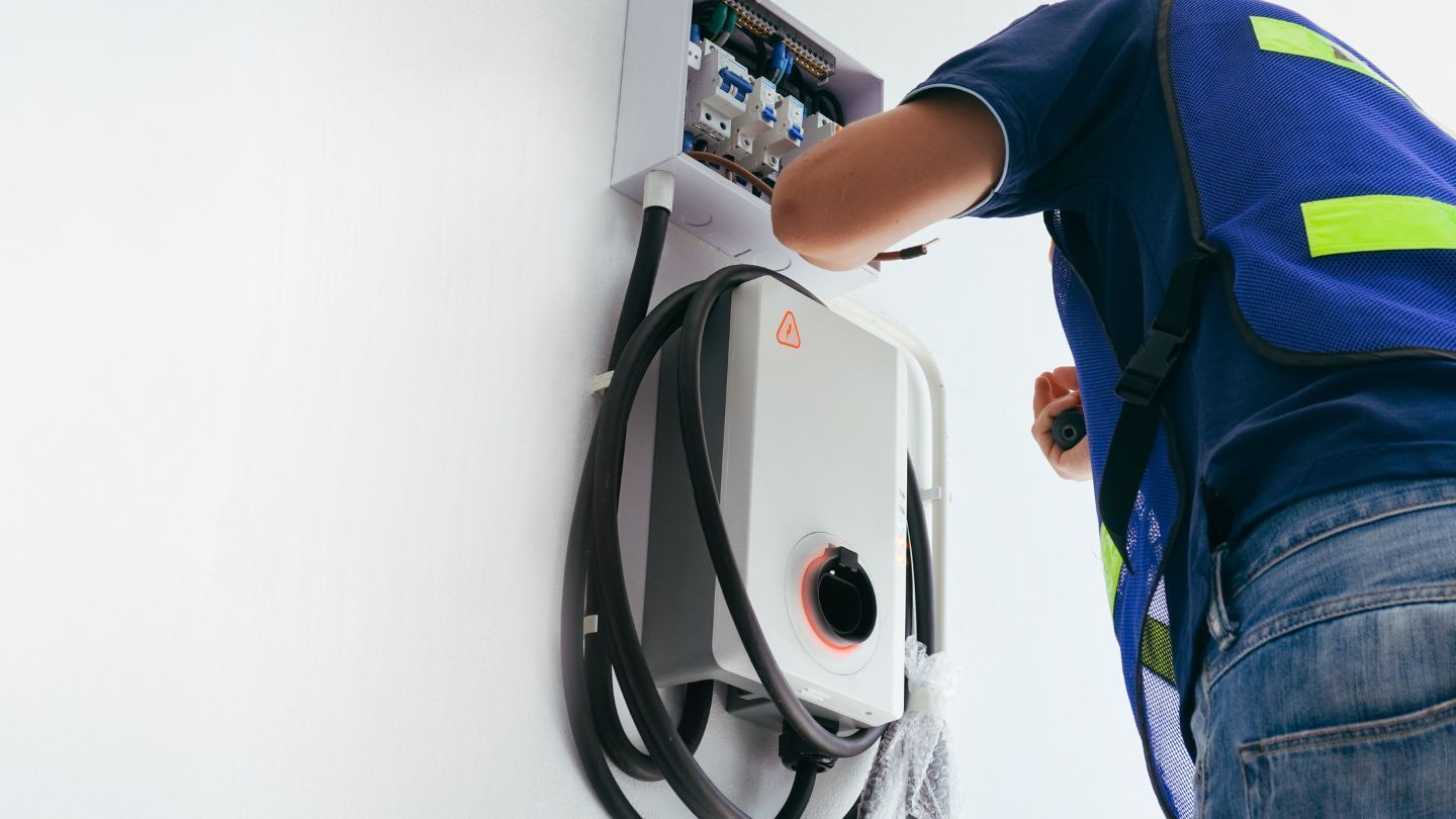 A metal roof with a skylight against a bright blue sky.