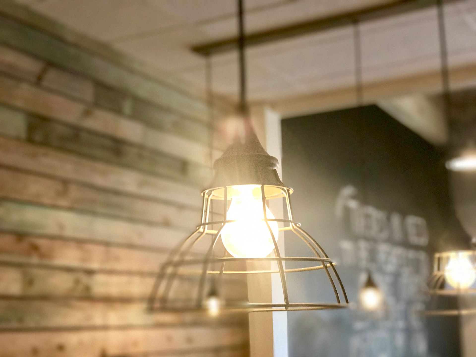 Warm pendant lights hanging in a rustic wood-and-brick interior