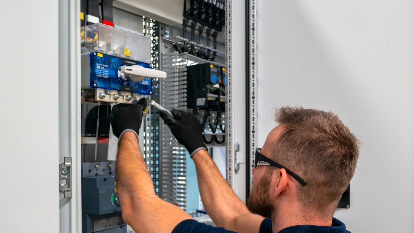 Close-up of gray corrugated metal roofing, with curved ridges and openings.