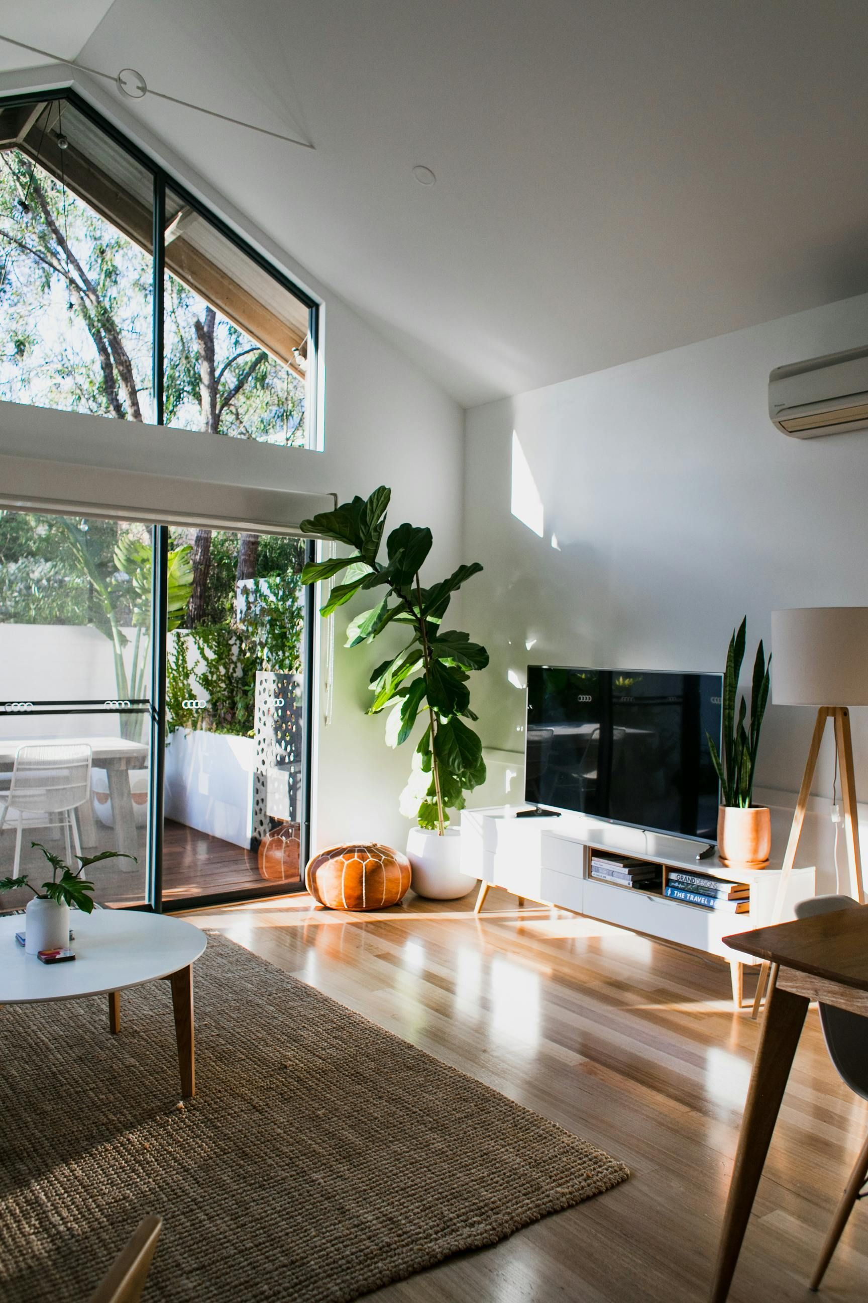 A living room with a sliding glass door and a flat screen tv.