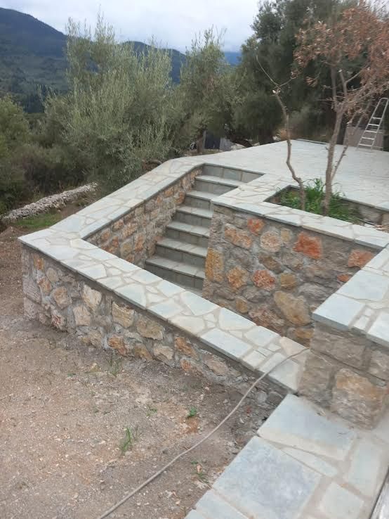 A stone wall with stairs leading up to it