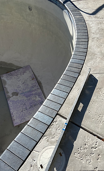 A close up of a swimming pool with a tile border.