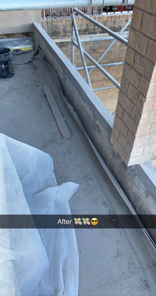A person is taking a picture of a balcony under construction.