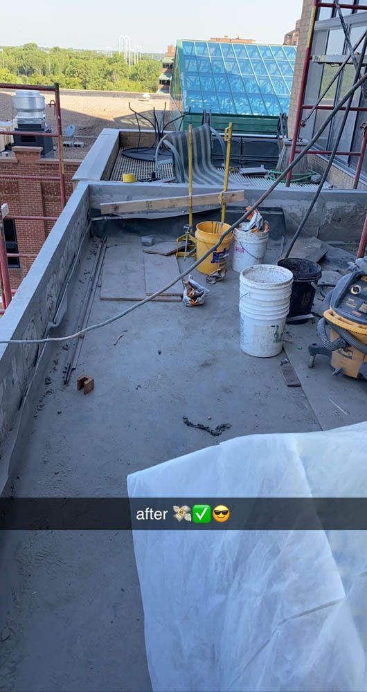 A snapchat of a roof with buckets and tools on it.