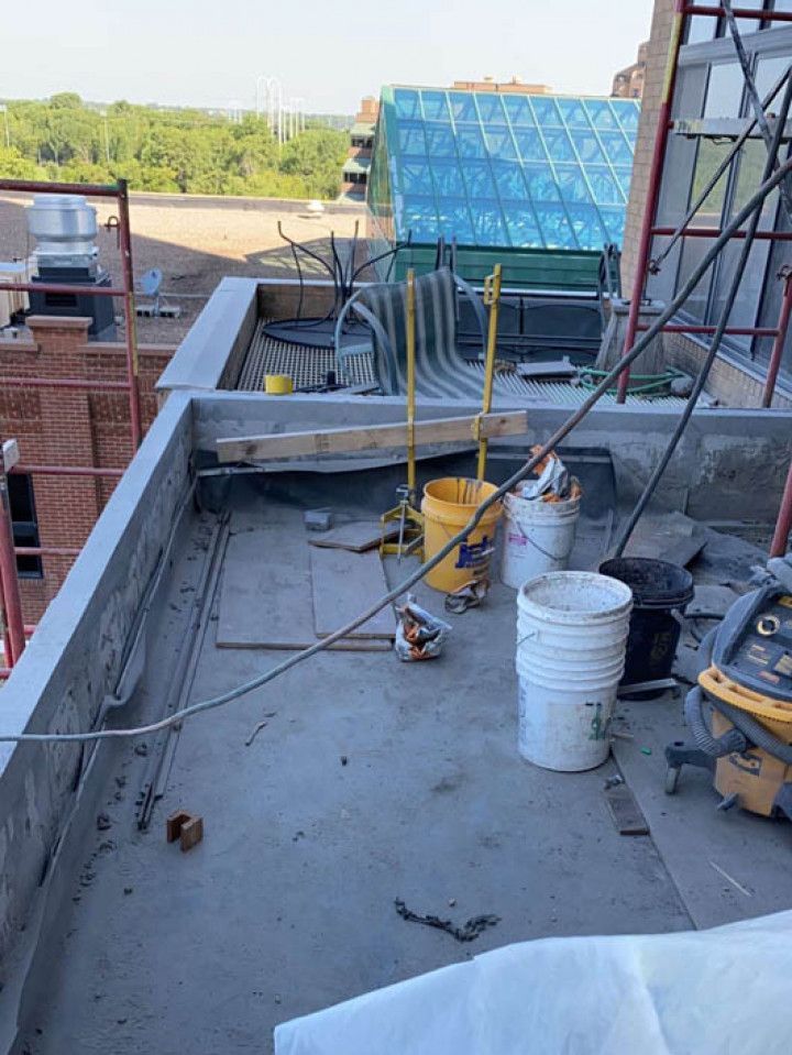 A construction site with buckets and tools on the ground.