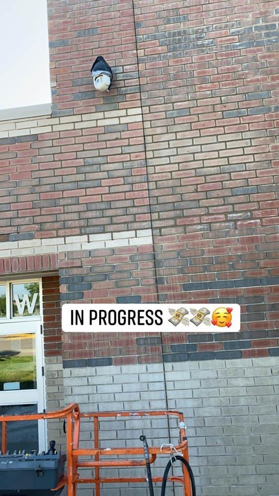 A brick wall with a sign that says `` in progress '' on it.
