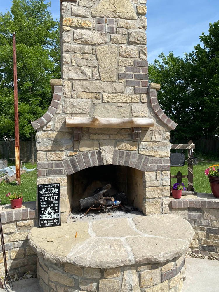 A stone fireplace with a sign that says believe in yourself