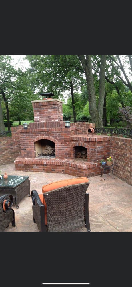 There is a fireplace in the middle of the patio.