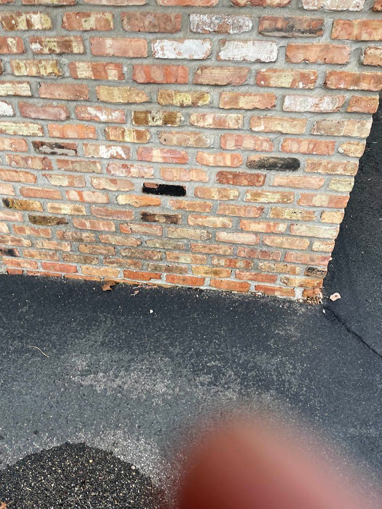 A close up of a brick wall with a hole in it.