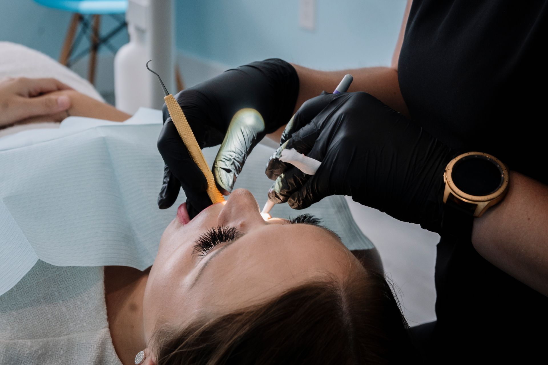 Dentist working on a patient's teeth. Dental tools, black gloves, open mouth, dental chair. 
Harbour Grace Dental Hygiene
