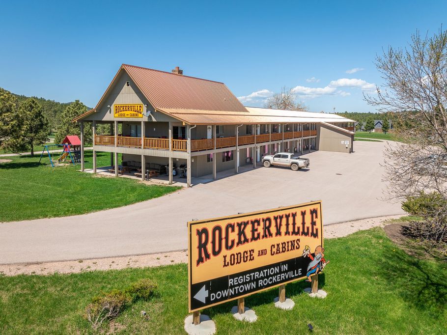 Rockerville Lodge and Cabins, two-story building with a sign on a sunny day.