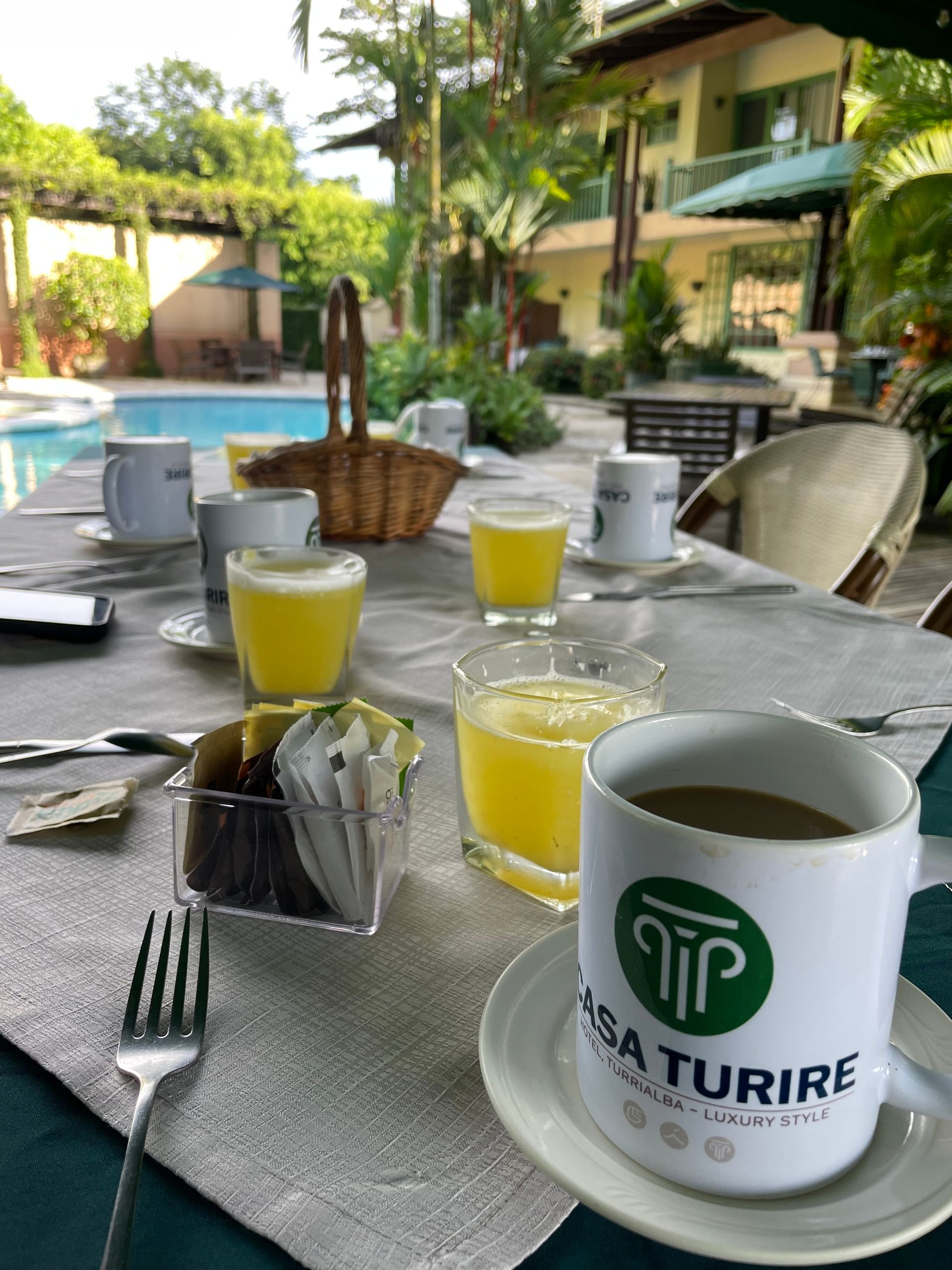 A table with a cup of coffee and a cup of orange juice on it.