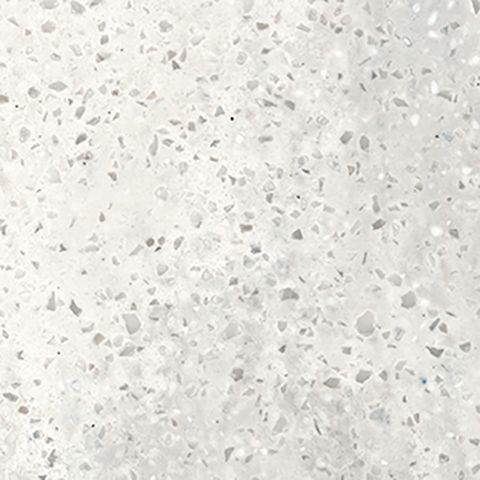 Et nærbillede af en hvid granitbordplade med små sten på.