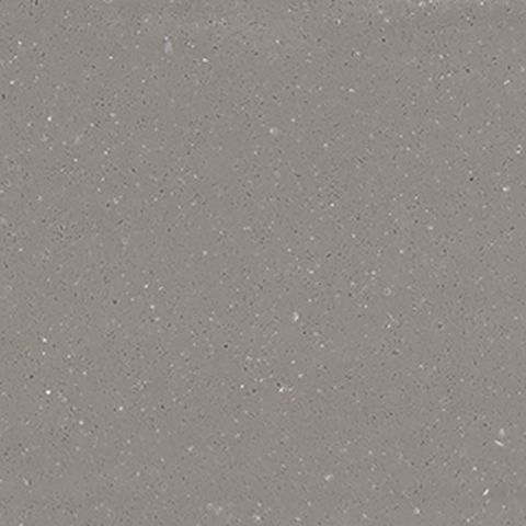 Et nærbillede af en grå flise med små hvide prikker på.