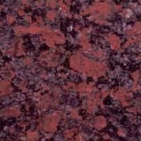 Et nærbillede af en bordplade i rød granit.
