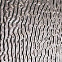 Et nærbillede af en metaloverflade med et hvirvelmønster.