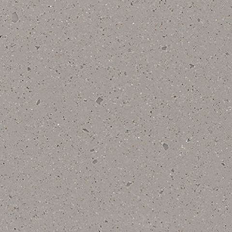 Et nærbillede af en grå flise med små sten på.