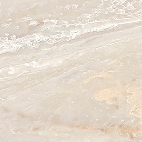 Et nærbillede af en hvid flise med marmortekstur.