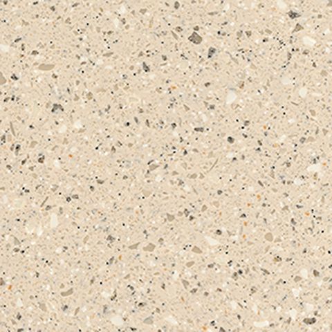 Et nærbillede af en bordplade i beige granit med en masse små sten på.