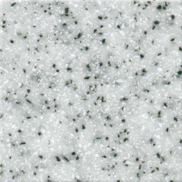 Et nærbillede af en hvid granitbordplade med sorte pletter.