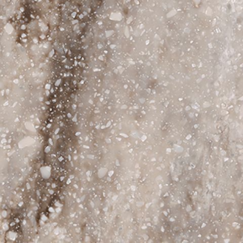 Et nærbillede af en bordplade i marmor med små hvide sten