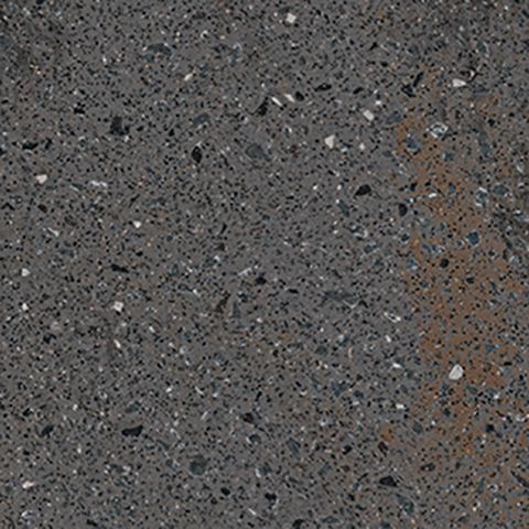 Et nærbillede af en grå flise med en masse små sten på.