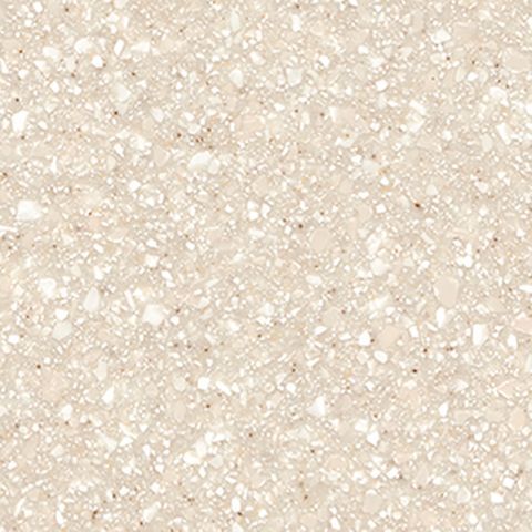 Et nærbillede af en bordplade i beige granit med små hvide sten.