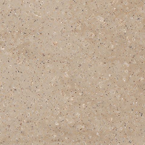 Et nærbillede af en beige flise med små prikker på