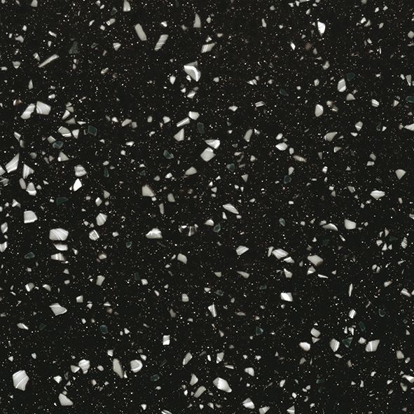 Et nærbillede af en sort overflade med hvide sten på