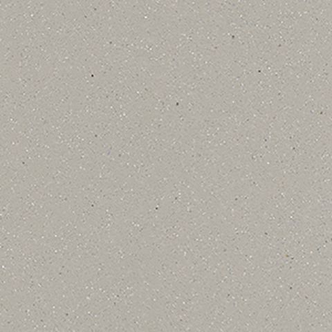 Et nærbillede af en grå flise med små prikker på.