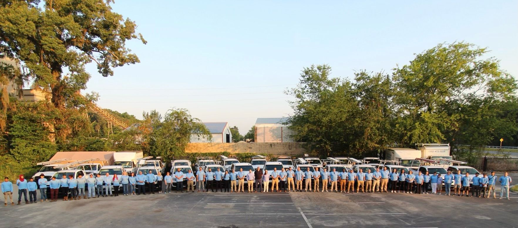 A large group of people are standing in a parking lot.