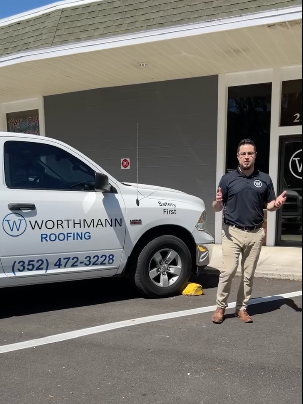 a man standing in front of a worthmann roofing truck