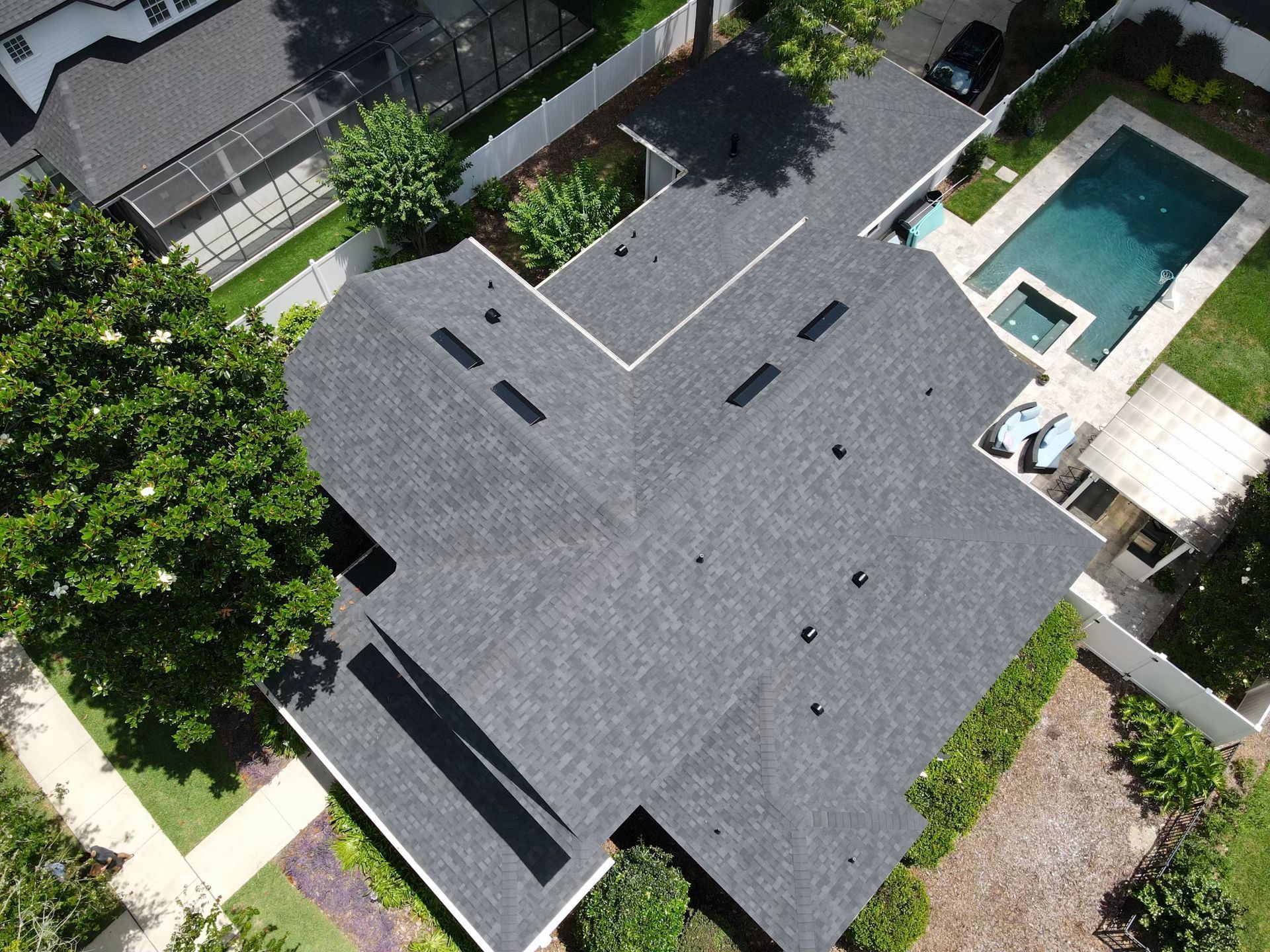 An aerial view of a house with a pool in the backyard