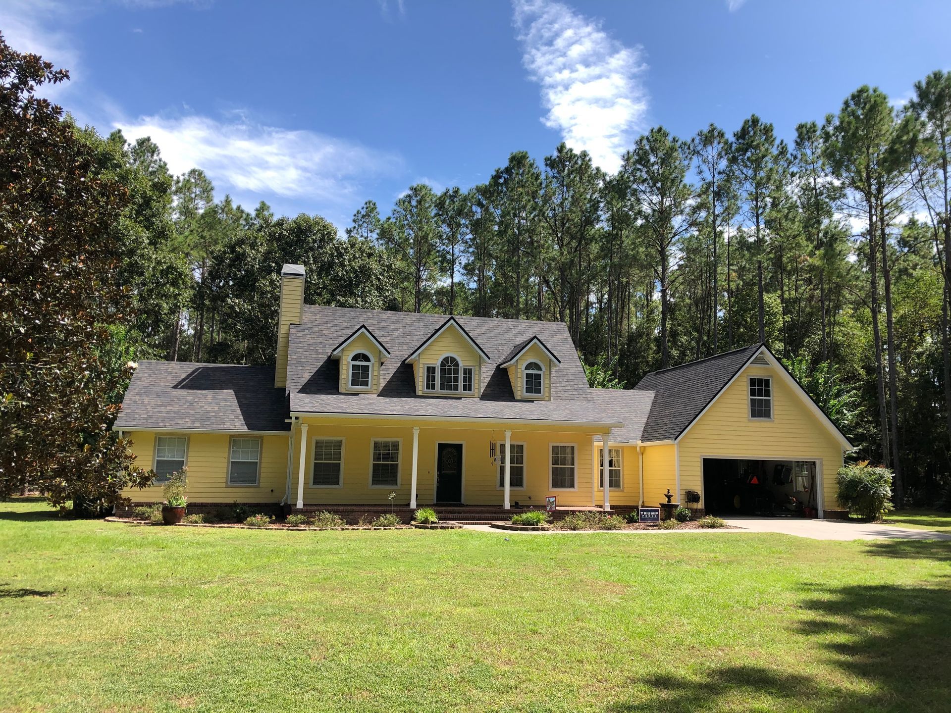 Residential property with yellow siding and shingle roofing in Gainesville