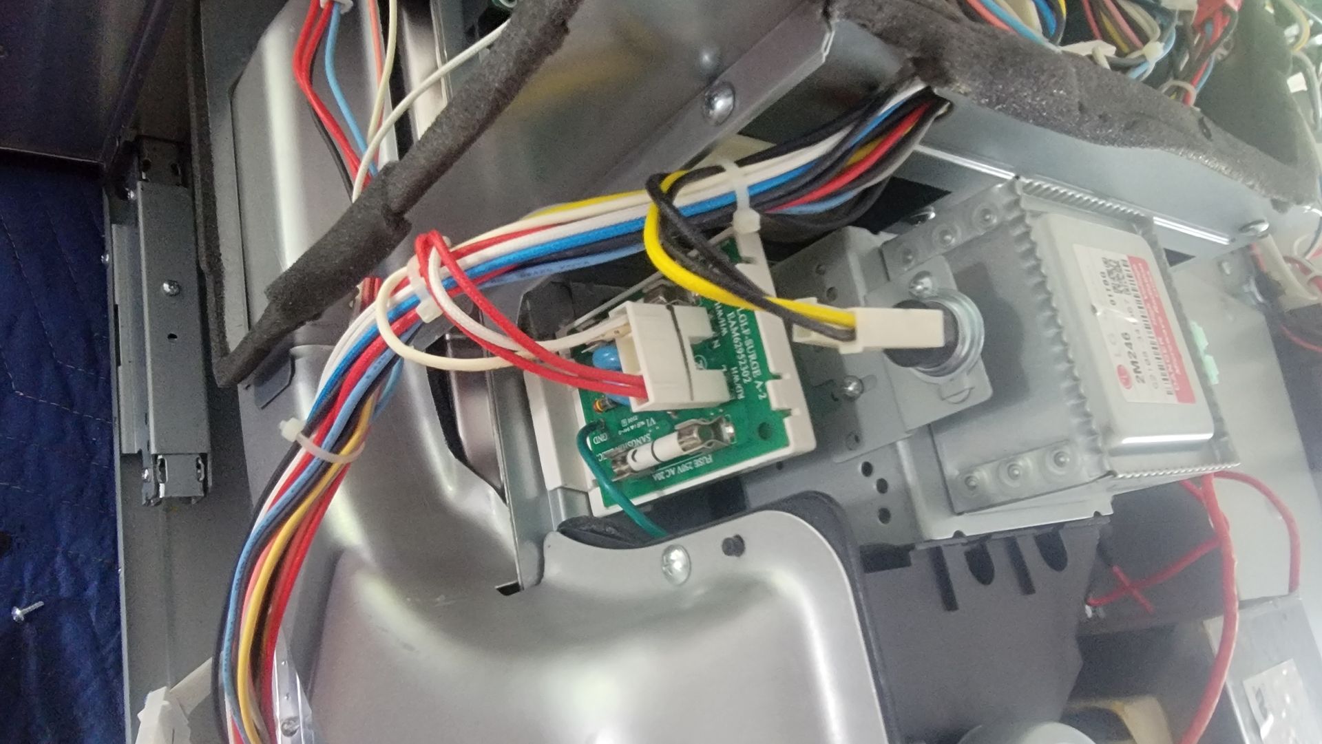 A bunch of wires are connected to a microwave oven.