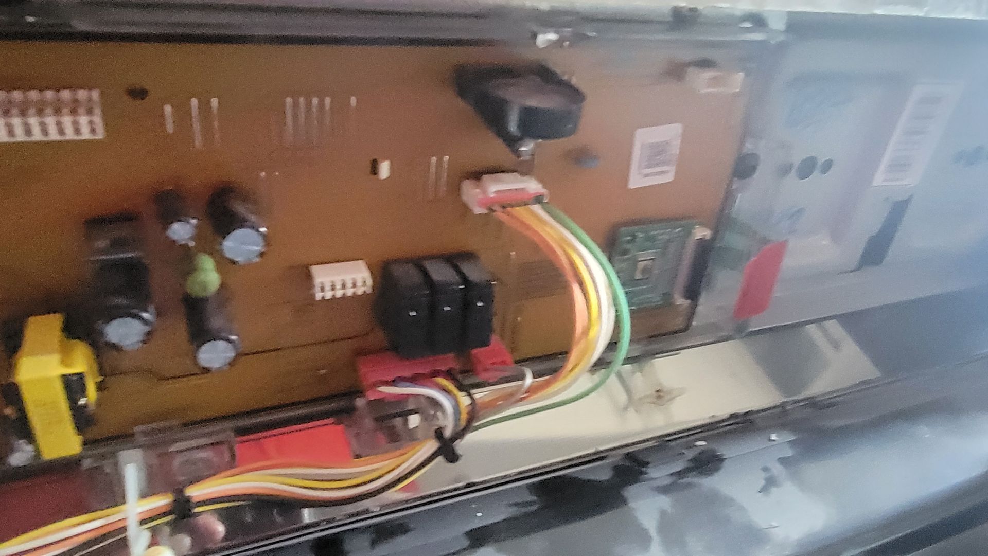 A close up of a motherboard with a bunch of wires coming out of it.