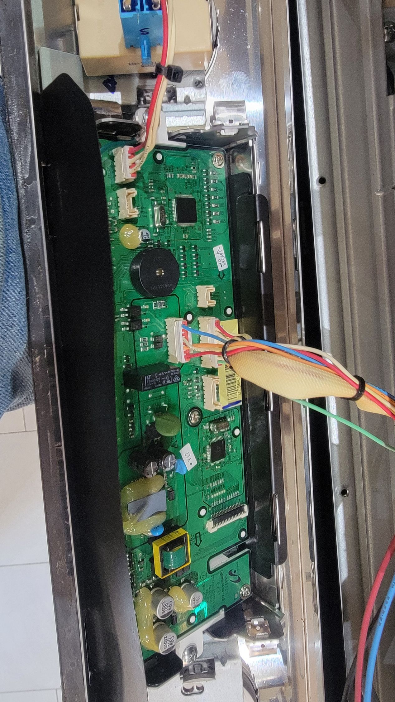 A close up of a motherboard with wires coming out of it.