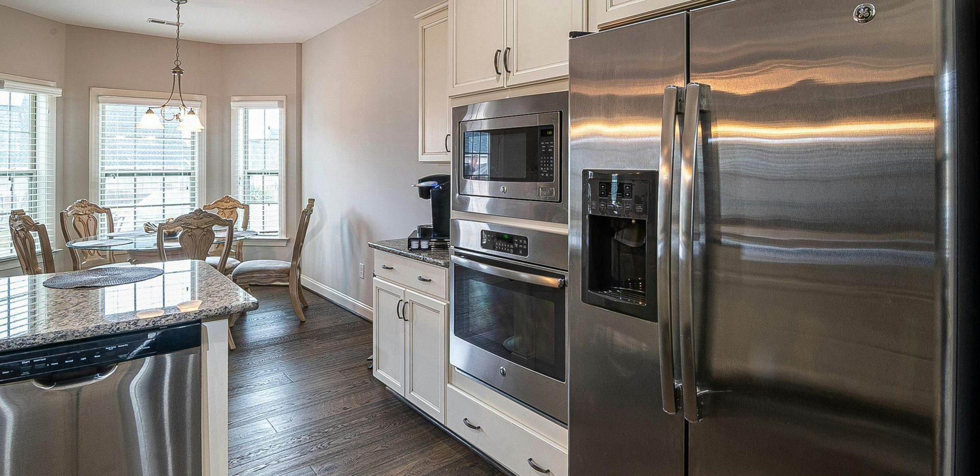 A kitchen with stainless steel appliances and a stainless steel refrigerator.