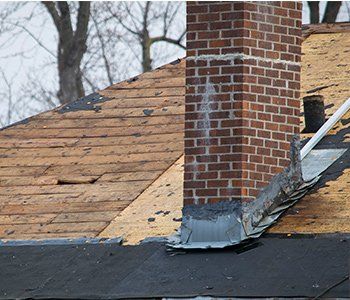 Repair To Chimney — Damaged and old roofing shingles on a house in Lititz, PA