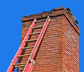 Chimneys Maintenance — Old Chimney with red metal ladder in Lititz, PA