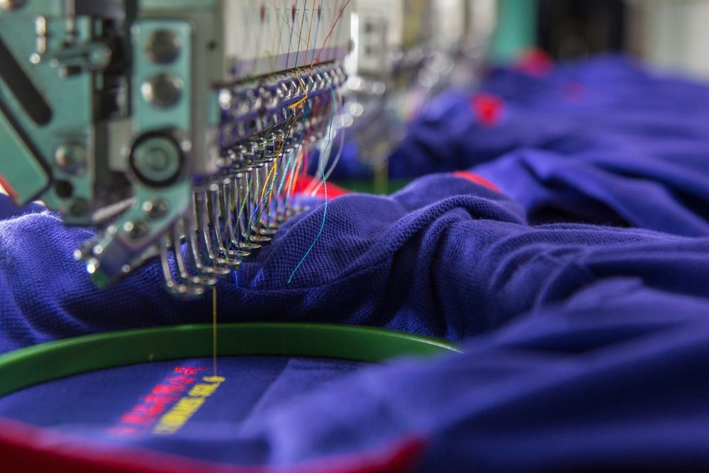 A Close Up of a Machine Embroidery On a Blue Shirt — Embroidery Express in Nambour, QLD